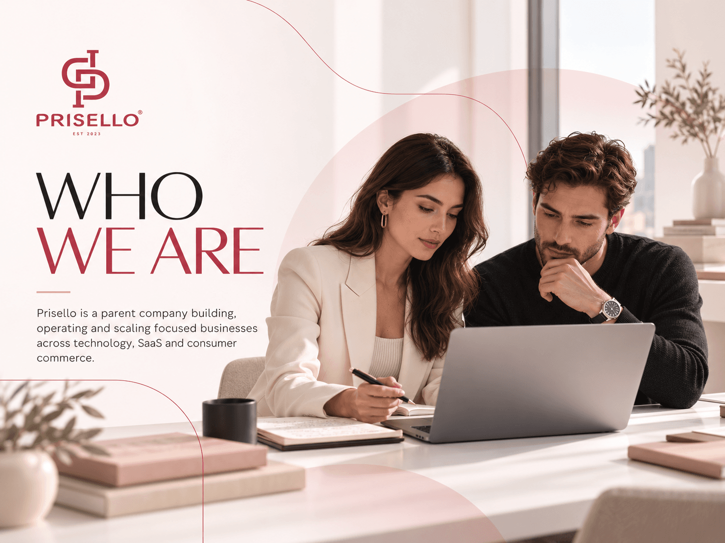 Two Prisello Group colleagues working together at a laptop in a bright office